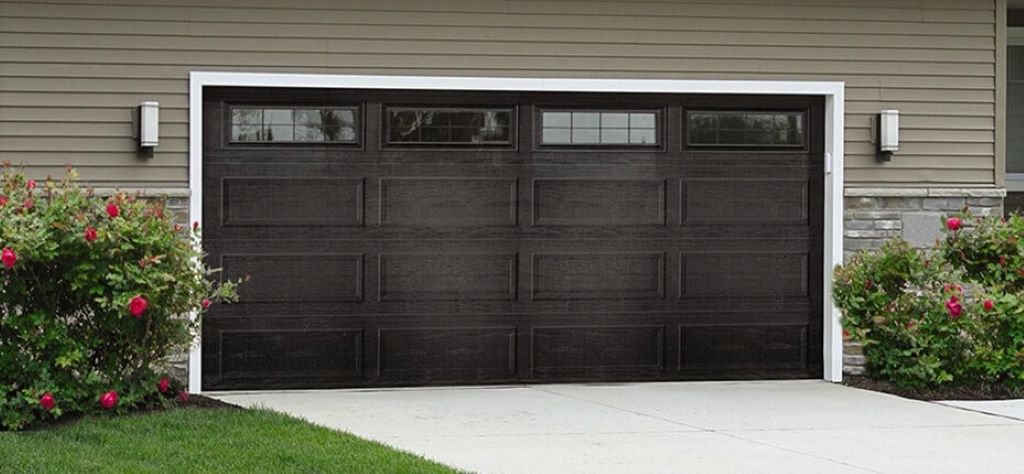 Modern glass and wood garage door with smart technology features enhancing home design in 2025