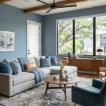 Modern Austin living room with dusty blue walls, neutral sofa, and natural wood furniture