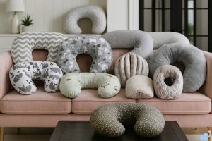 Close-up of ergonomic baby nursing pillow on a bed